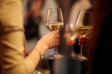 The girl holds a glass in her hand. Champagne. A party 