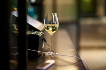 A glass of white wine and champagne is on the table. Wine. 