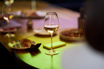 A glass of white wine and champagne is on the table. Wine. 