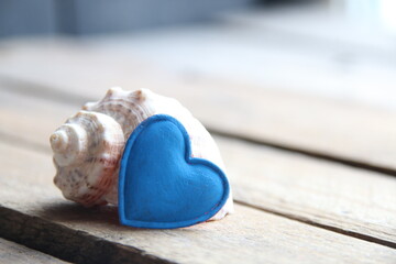 Shell on a wooden background. Marine background. Or birthday background.