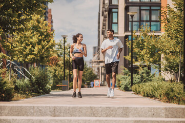 Fototapeta premium Cheerful couple enjoying their morning jog outdoors
