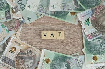 VAT is value added tax. Flat lay with Polish złoty money, PLN zloty banknotes. Rising economics...