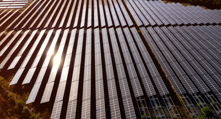 Photovoltaic solar panels at sunrise and sunset.Solar panel cell on dramatic sunset sky background,clean Alternative power energy concept.