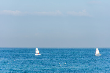 Two sailing boats on the blue Mediterranean in Algiers city. Water sports.