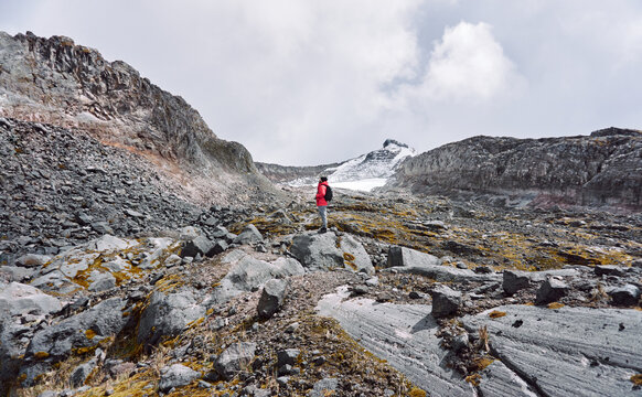 Hiker standing on rock admiring rocky hills