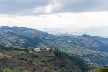 Scenic view of a village on the top of the mountain on a cloudy day.