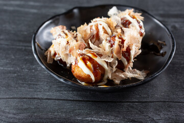 A view of a plate of takoyaki.