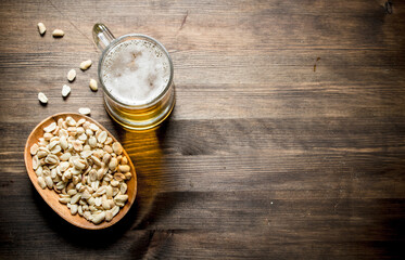 Beer and peanuts in the bowl.