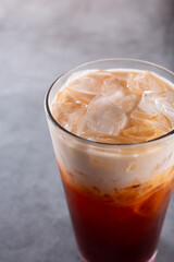 A closeup view of a glass of cold Thai tea.