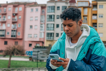 urban young man in the street looking at the mobile phone