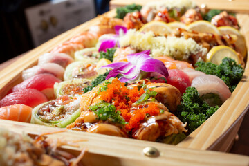 A closeup view of a sushi boat, featuring a variety of sushi pieces. © DAVID