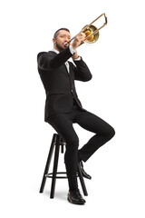 Male musician sitting on a chair and playing a trombone