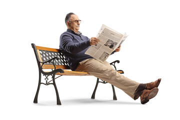 Mature man sitting on bench and reading a newspaper - Powered by Adobe