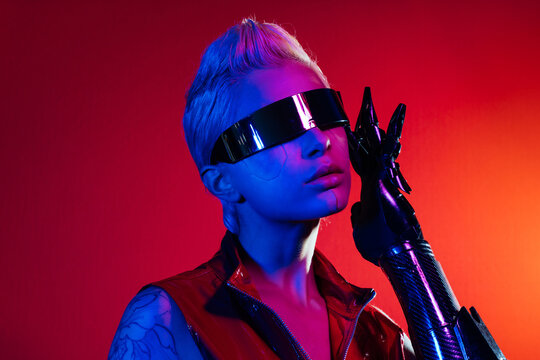 Representation of a bionic super human with advanced technology parts as vr visors and gadgets playing in a mixed reality training room. Futuristic cyberpunk evolution of human mankind and AI