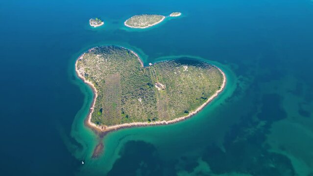 Aerial drone view of Galesnjak the Island of Love in Croatia with beautiful blue turquoise sea water. Heart shaped Island. Travel and holidays destination. Amazing tourism in Croatia Islands.