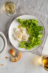 Fresh vegetables lattuce with stracciatella cheese.