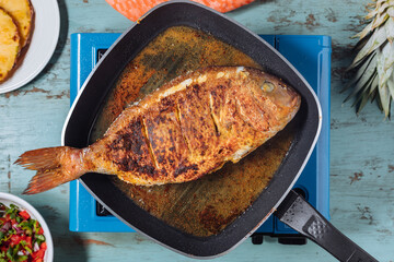 Red Snapper with ingredients. Prepared in tropical taste with Pico de Gallo and pineapple. Fresh and tasty fish and seafood. 