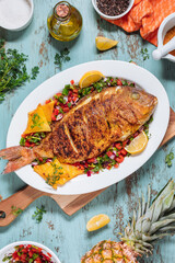 Red Snapper with ingredients. Prepared in tropical taste with Pico de Gallo and pineapple. Fresh and tasty fish and seafood.  - obrazy, fototapety, plakaty