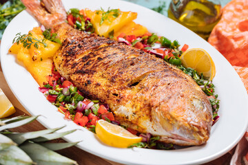 Red Snapper with ingredients. Prepared in tropical taste with Pico de Gallo and pineapple. Fresh and tasty fish and seafood. 