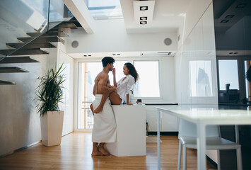 Young couple lifestyle moments at home. Playful young woman and man having fun in a beautiful luxury penthouse loft apartment