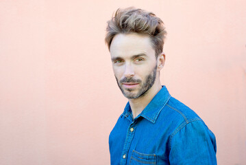 Portrait of handsome hipster guy looking at camera with serious face.