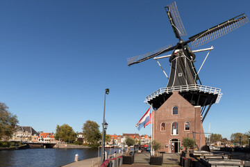 Fototapeta na wymiar Windmill De Adriaan from 1779 on the river Spaarne in Haarlem.