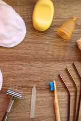 Various zero waste beauty products and kitchen utensils on wooden background. Top view.