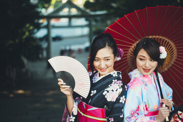 Two japanese girls wearing kimonos traditional clothes, lifestyle moments