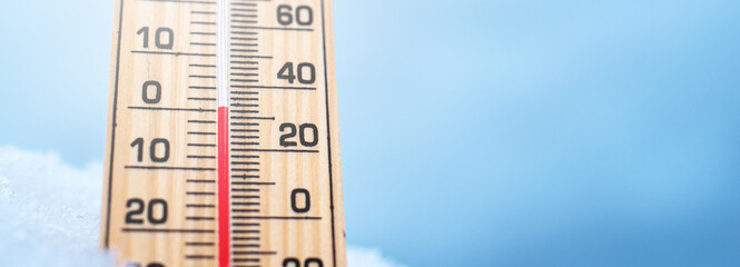 Thermometer in the snow. Winter thermometer. Low temperatures in celsius or fahrenheit.