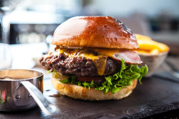 Chicken burger with avocado and 2 cheeses. Delicious healthy traditional food closeup served for lunch in modern gourmet cuisine restaurant