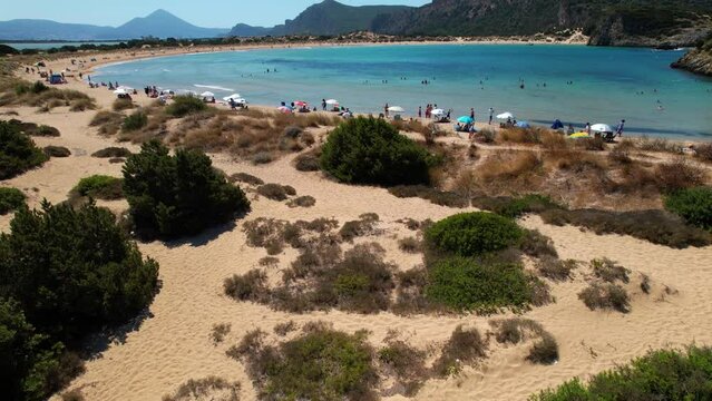 Aerial drone video of the iconic  semicircular sandy beach of Voidokoilia in Messinia, Gialova, Peloponnese, Greece