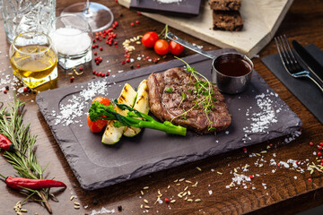 Black Angus New York steak. Marbled beef sirloin from Uruguay. Delicious healthy traditional food closeup served for lunch in modern gourmet cuisine restaurant