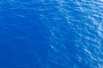 Very nice sea water background or backdrop with selective focus. Small waves of natural water surface texture.