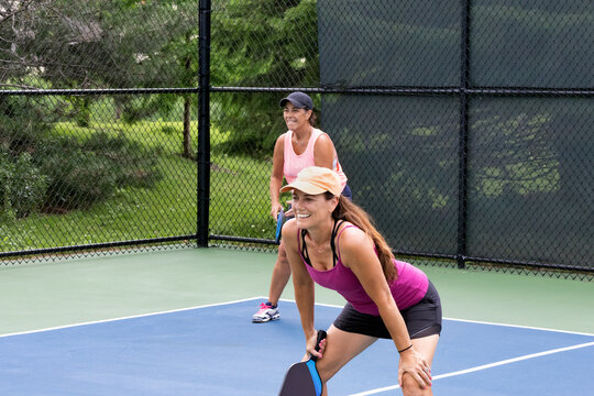 Two pickleball players prepare for action