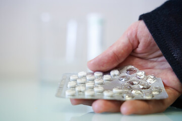 a person takes out a pill from the tablet with copy space. immunity to virus
