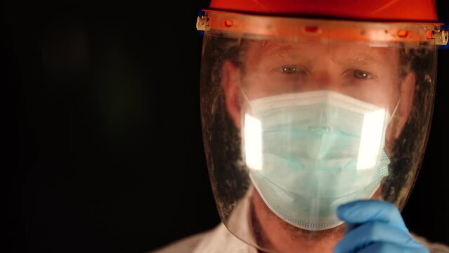 Australian person putting on safety equipment and a mask in a workplace in an industry