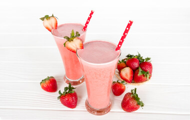 Strawberry yogurt fruit juice smoothie pink colorful fruit juice milkshake blend beverage healthy high protein the taste yummy In glass drink episode morning on white wood background.