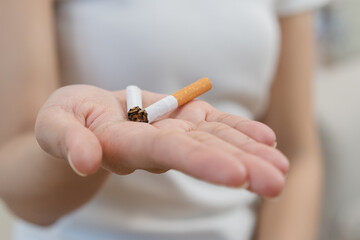 Close up hands of person refusing to smoke cigarette.