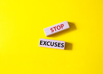Stop excuses symbol. Concept words Stop excuses on wooden blocks. Beautiful yellow background. Business and Stop excuses concept. Copy space.