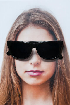photo of a brunette teenager girl with sunglasses over her eyes 