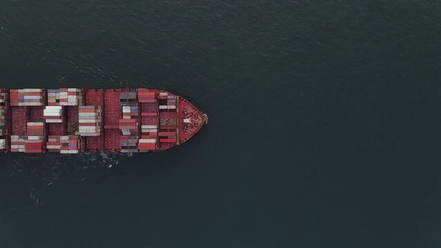 Air view of huge Container ship during underway inn open ocean. Vessel underway.