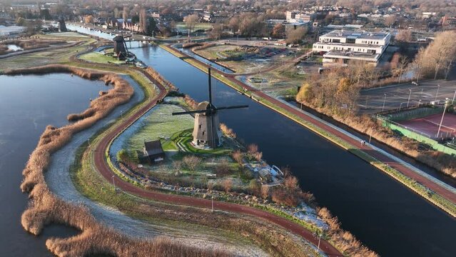 Strijkmolen E, Ouddorp, Alkmaar, North Holland,The Netherlands. Oak octagonal polder mill from 1630. Ironing mills do not drain polders, grind the water from one reservoir to the other. Winter aerial.