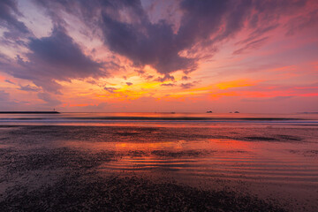 beach and sea in the morning,Calm sea with sunset sky and sun through the clouds over. Meditation ocean and sky background. Tranquil seascape. Horizon over the water.