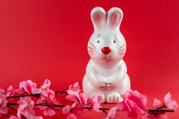 Rabbit coin bank Year of Rabbit concept and cherry blossom