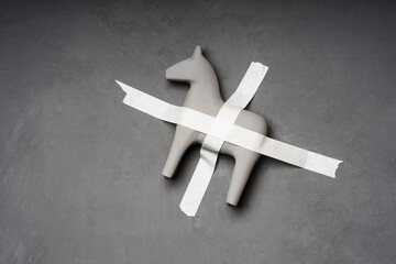 a gray horse is taped to a gray wall