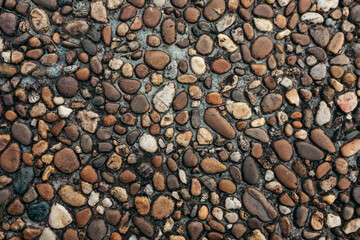Interesting background in the form of a roadway with stones of smooth shape