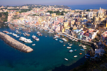 Procida island colorful town with small harbour from above, Italy