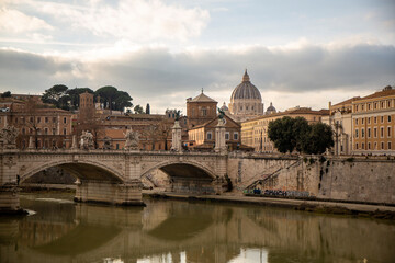 Fototapeta premium Bridge over the Tiber river in Rome with a view in the distance of Saint Peter's Basilica