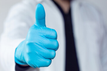 A doctor with his thumb up