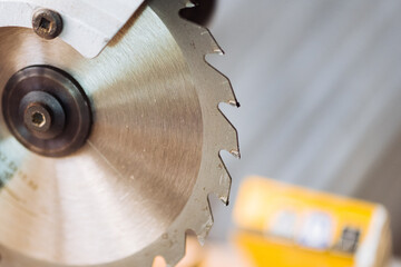 closeup of a circular saw blade on a construction site.